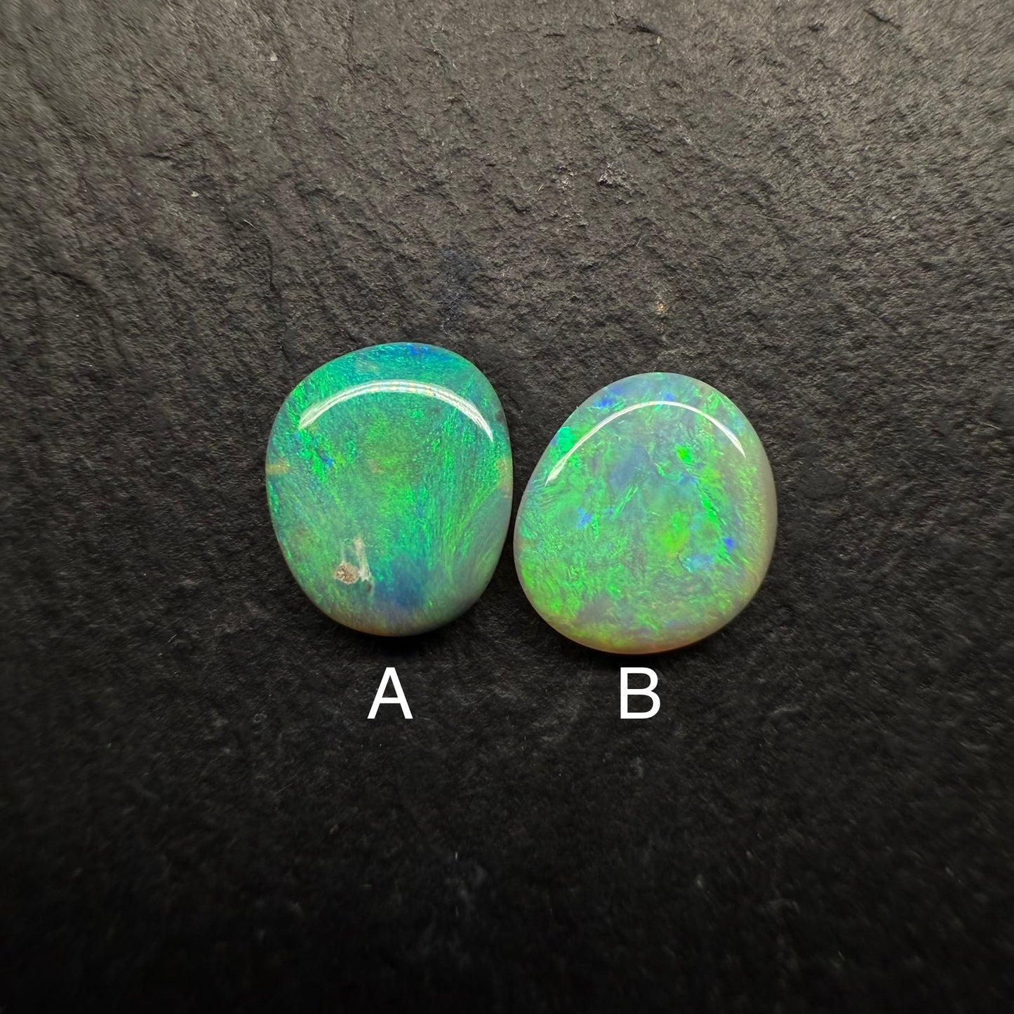 A Mismatched Pair Of Dark Opals With Moss patterns And A Minty Green Color Palette