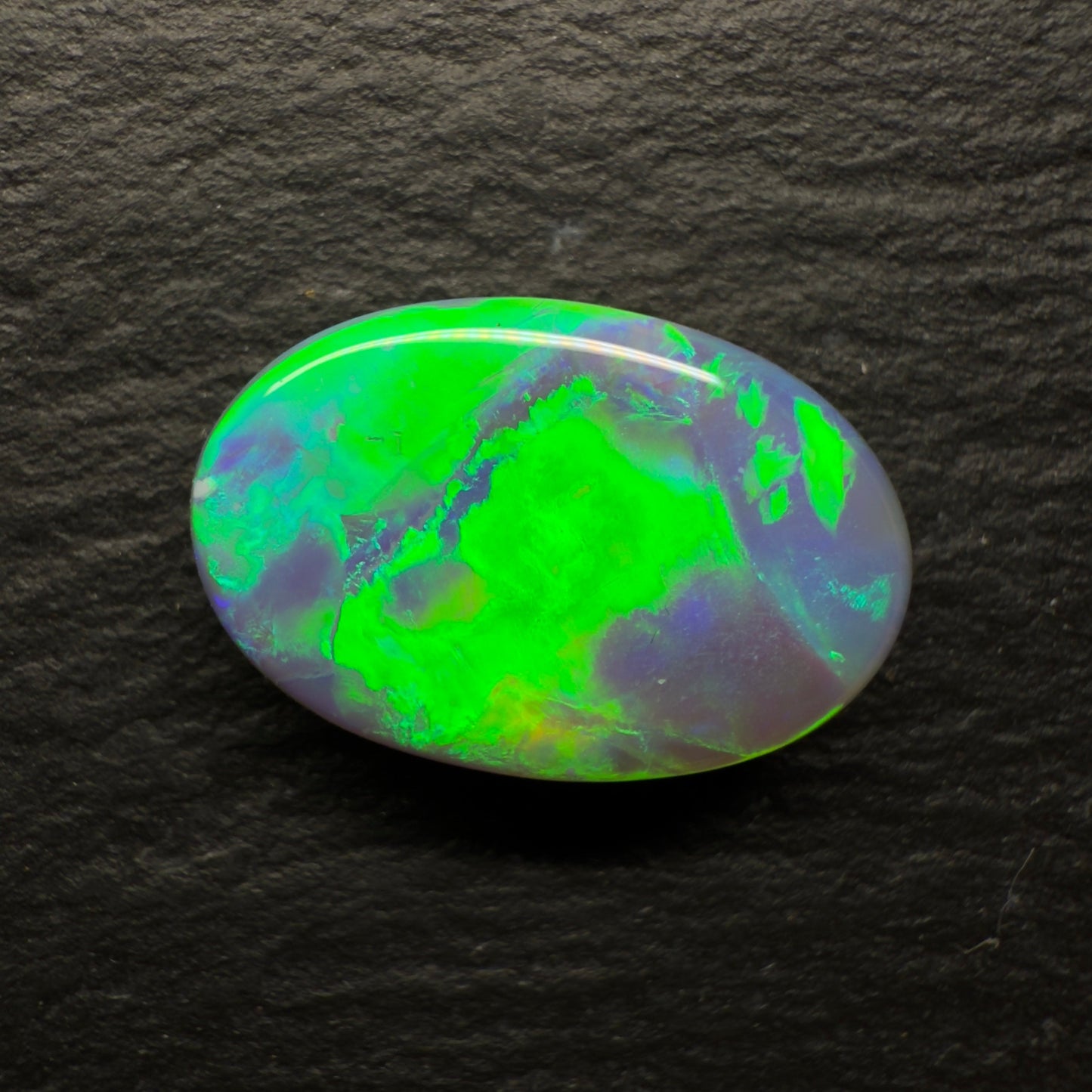 6.64ct World Class Black opal With Brilliant Green-Gold Color play And A Rolling Broad Flash Pattern