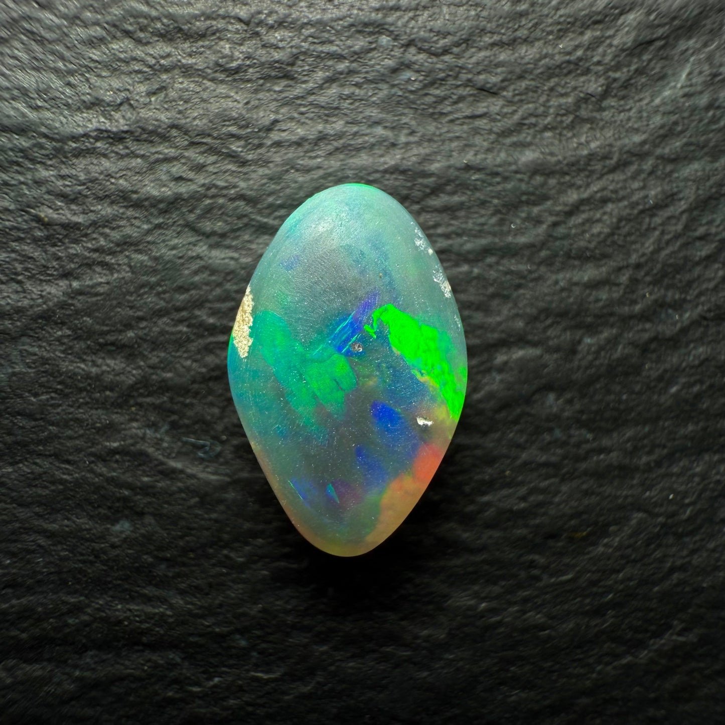 1.16ct Gem Black Opal, This Freeform Gem Has A Beautiful Array Of Orange Green and Gold with Hints Of Blue