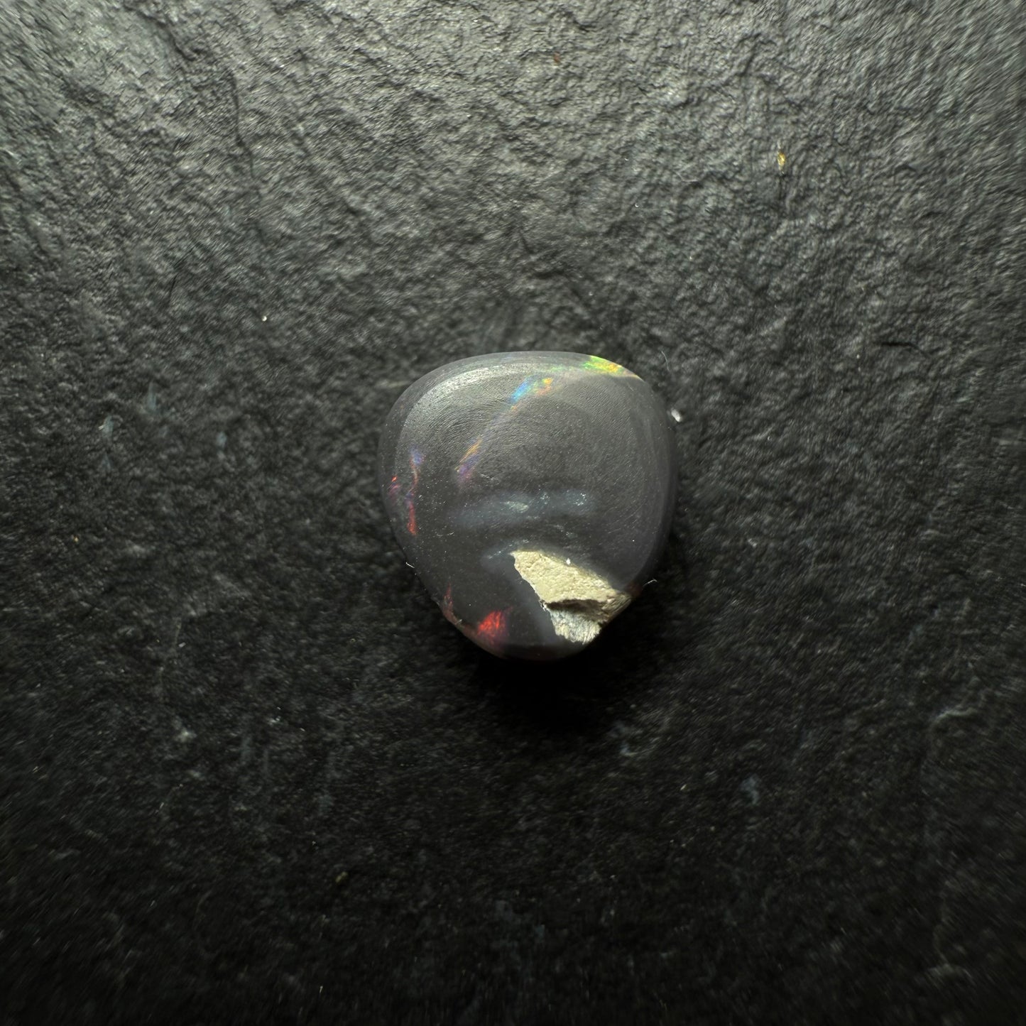 0.64ct Gem Black Opal With A Lovely Red Multi-Color Palette And Small Flash Pattern