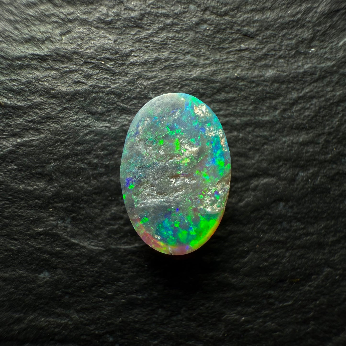 0.64ct Dark Crystal Opal With A Bright Blue Green Speckled Pinfire Like Pattern