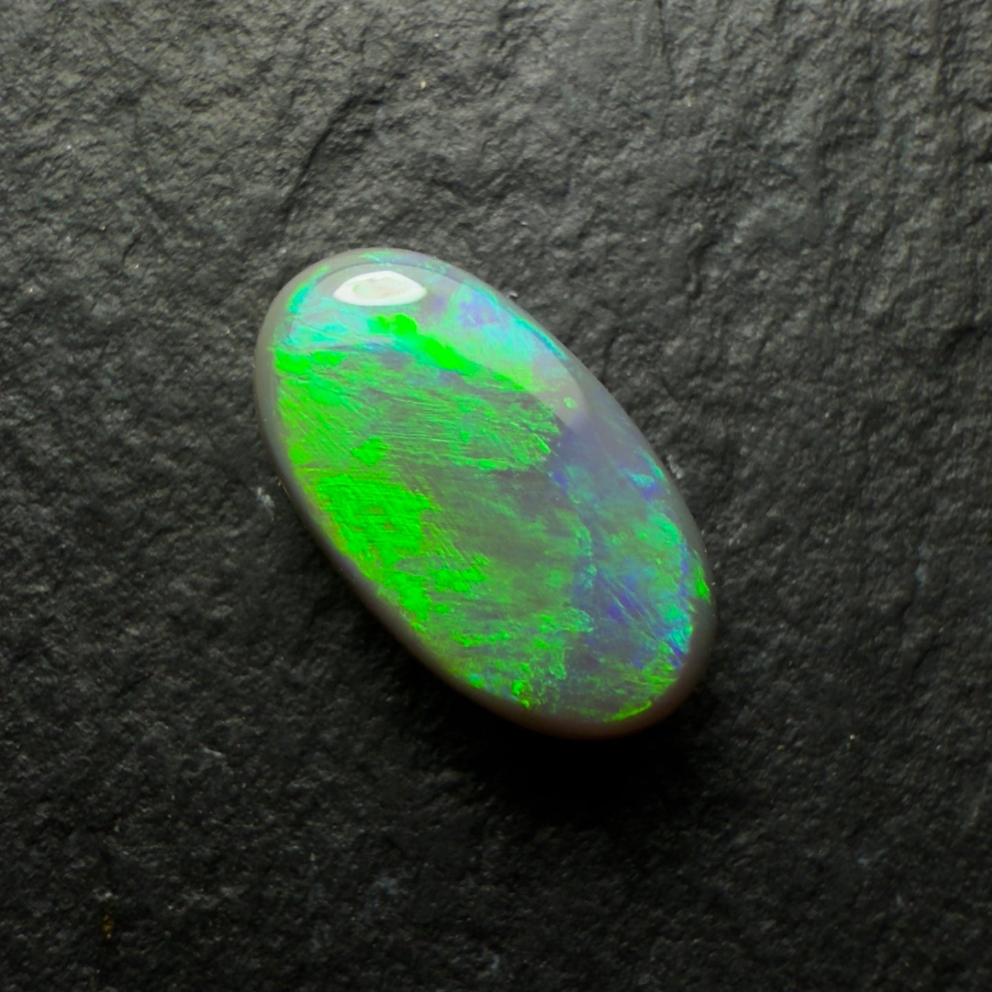 0.77ct Dark Opal, This Gem Has A Green-Gold Color Palette With A Textured Broadflash Pattern