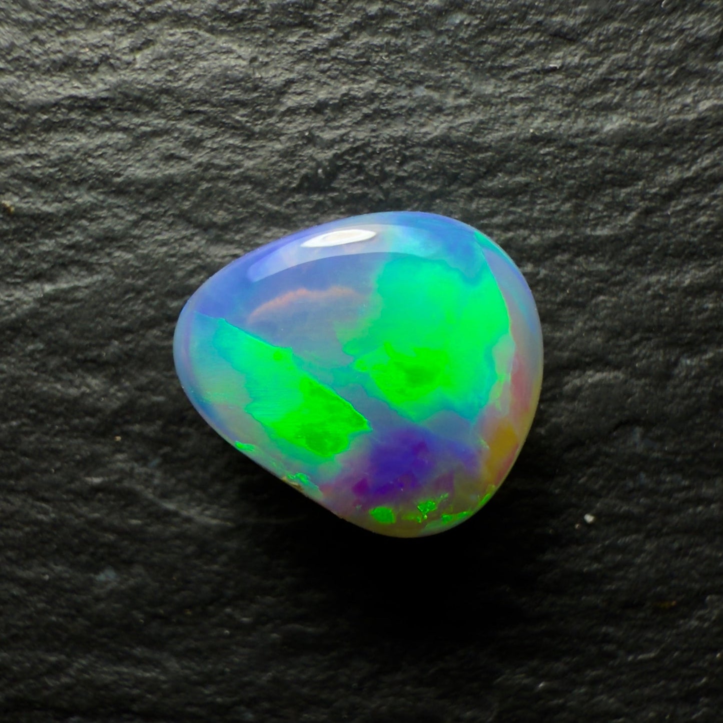 1.29ct black Opal, This Gem Has A Bright Green Blue Color Pallet With Rays Of Color Rolling Across The Stone