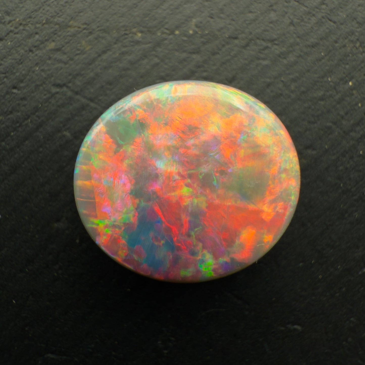 3.5ct Black Opal With A Rare Pink-Orange Broadflash Pattern, Shifting to Green As The Stone Is Moved