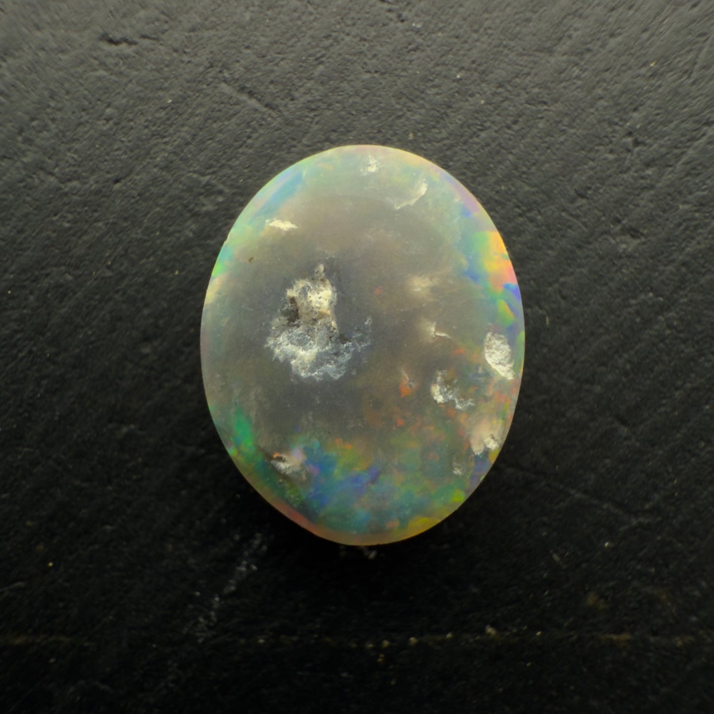 1.3ct Black Opal, With A vivid Orange Gold Color Palette And full faced Color