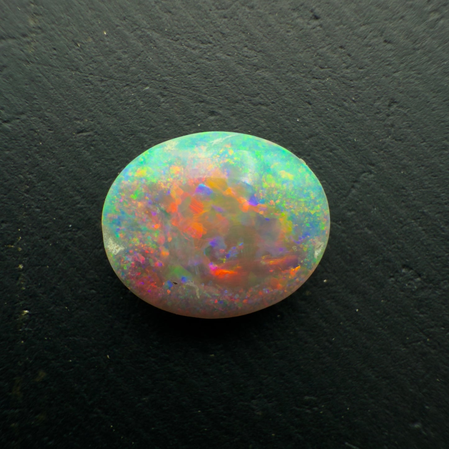 1.3ct Dark Crystal Opal With a Brilliant Red-Blue Color Palette And Full Faced Color