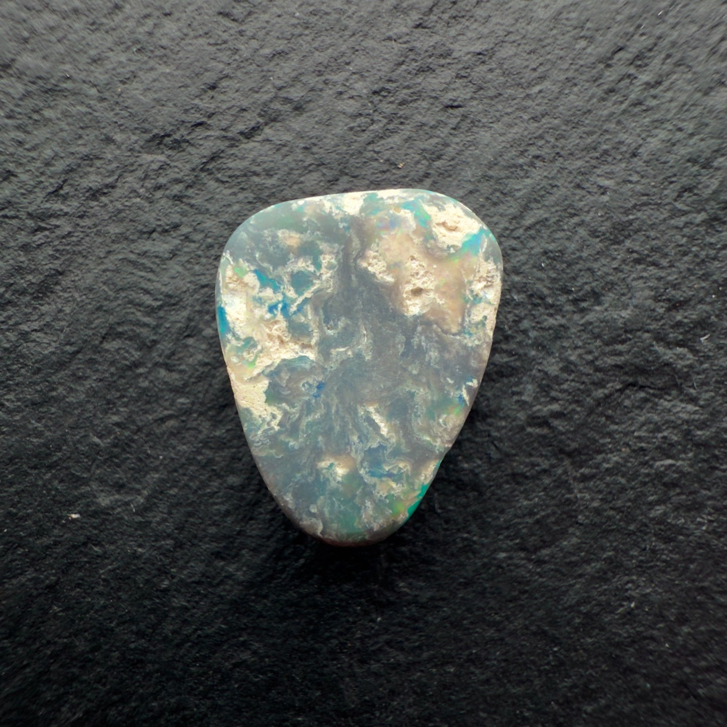 2.85ct Picture Stone Dark Opal With A Tropical Blue Green Color And Sandy colored Inclusions