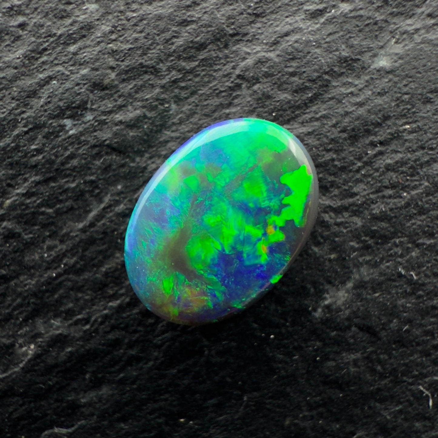 0.5cts Gem Black Opal With A Blocky Deep Green Blue Gold Pattern