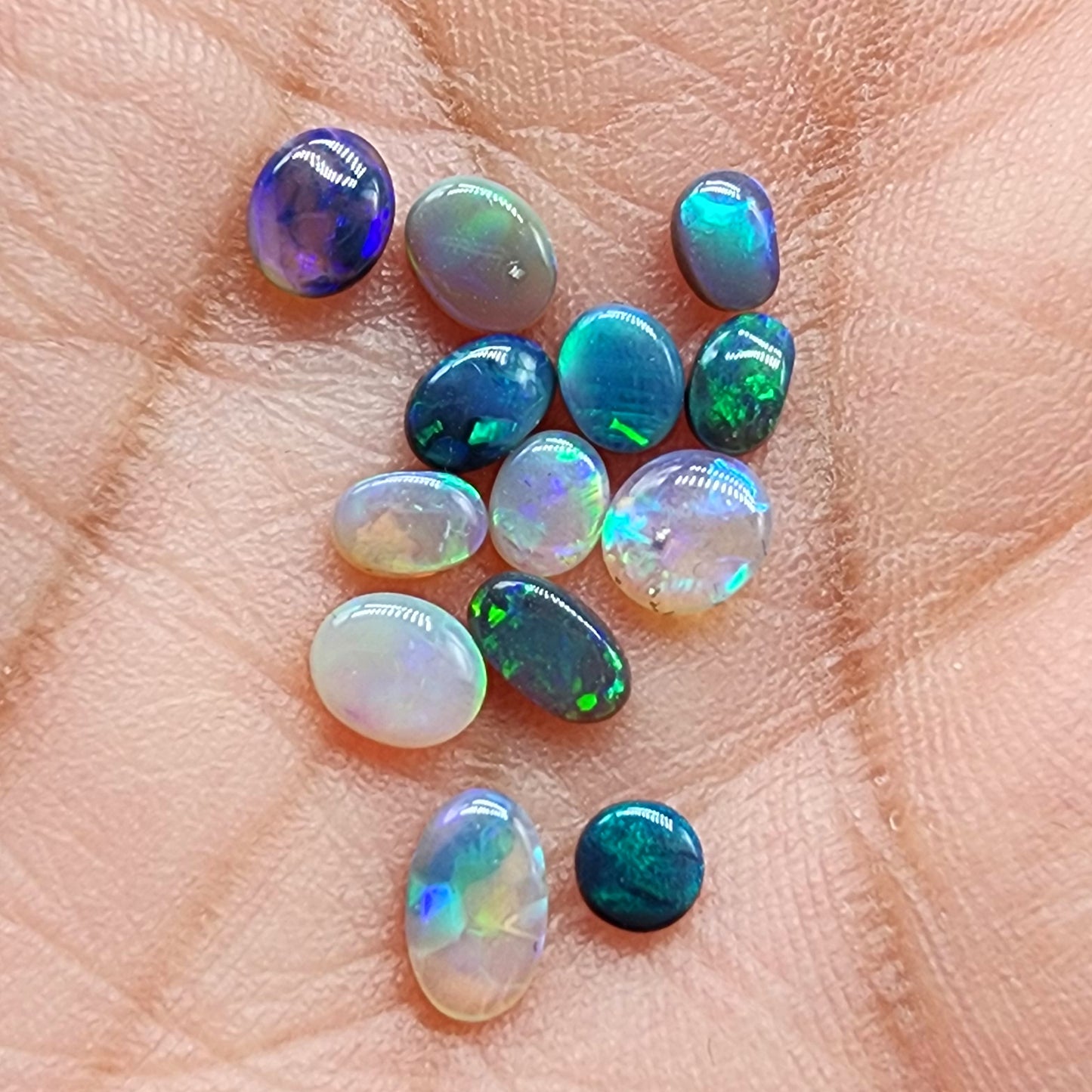 Assorted black opals, dark opals and crystal opals