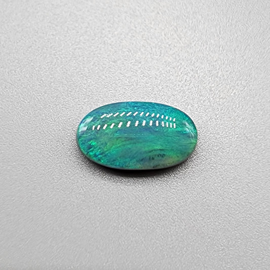 3.0ct teal colored black opal with a striated moss pattern