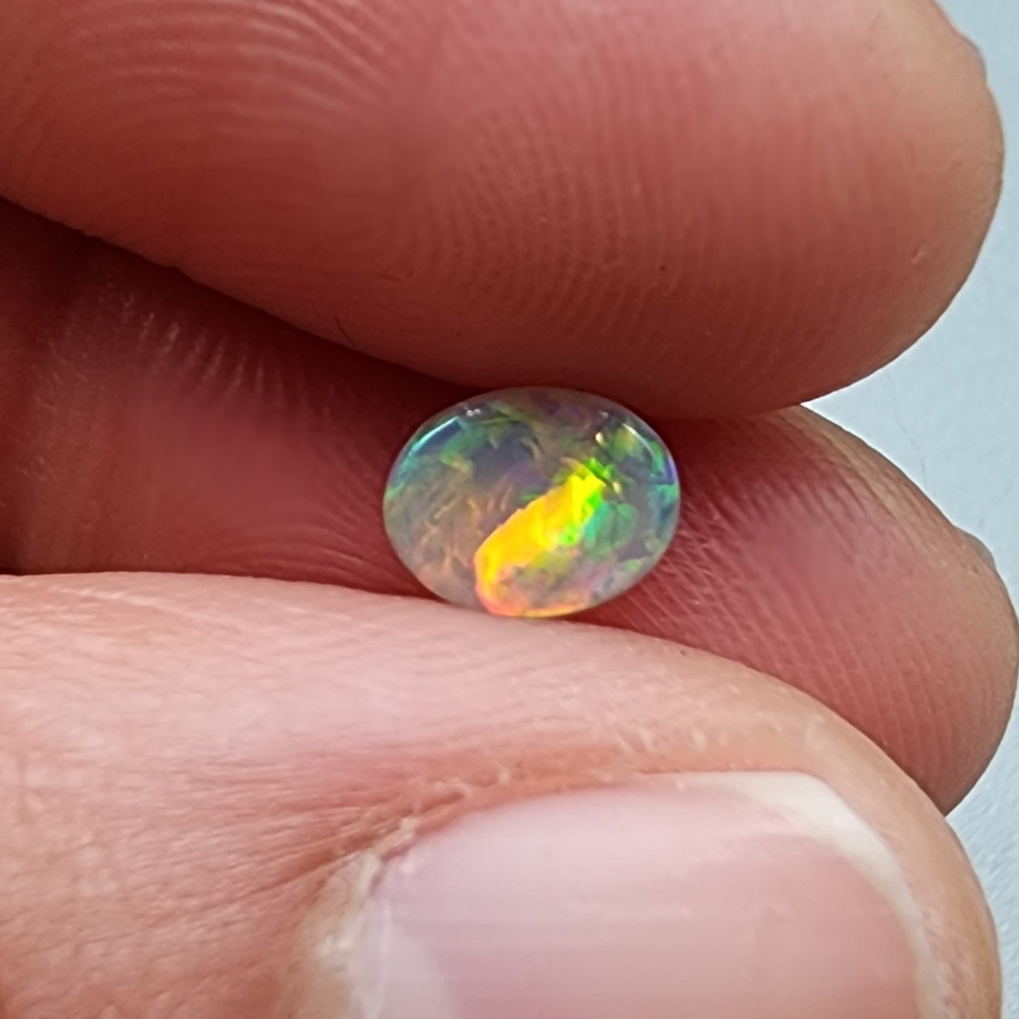 0.65ct Dark Opal with a multicolor pallet