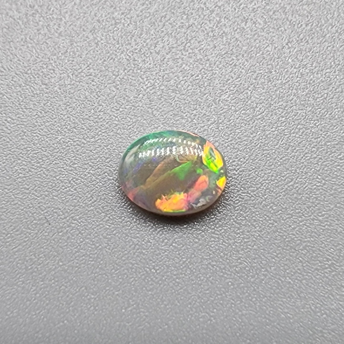 0.65ct Dark Opal with a multicolor pallet