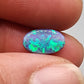 1.35ct Half black opal, half crystal opal with vivid green flash.