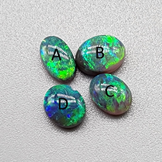 Assorted black opals with vivid greens, golds and blues