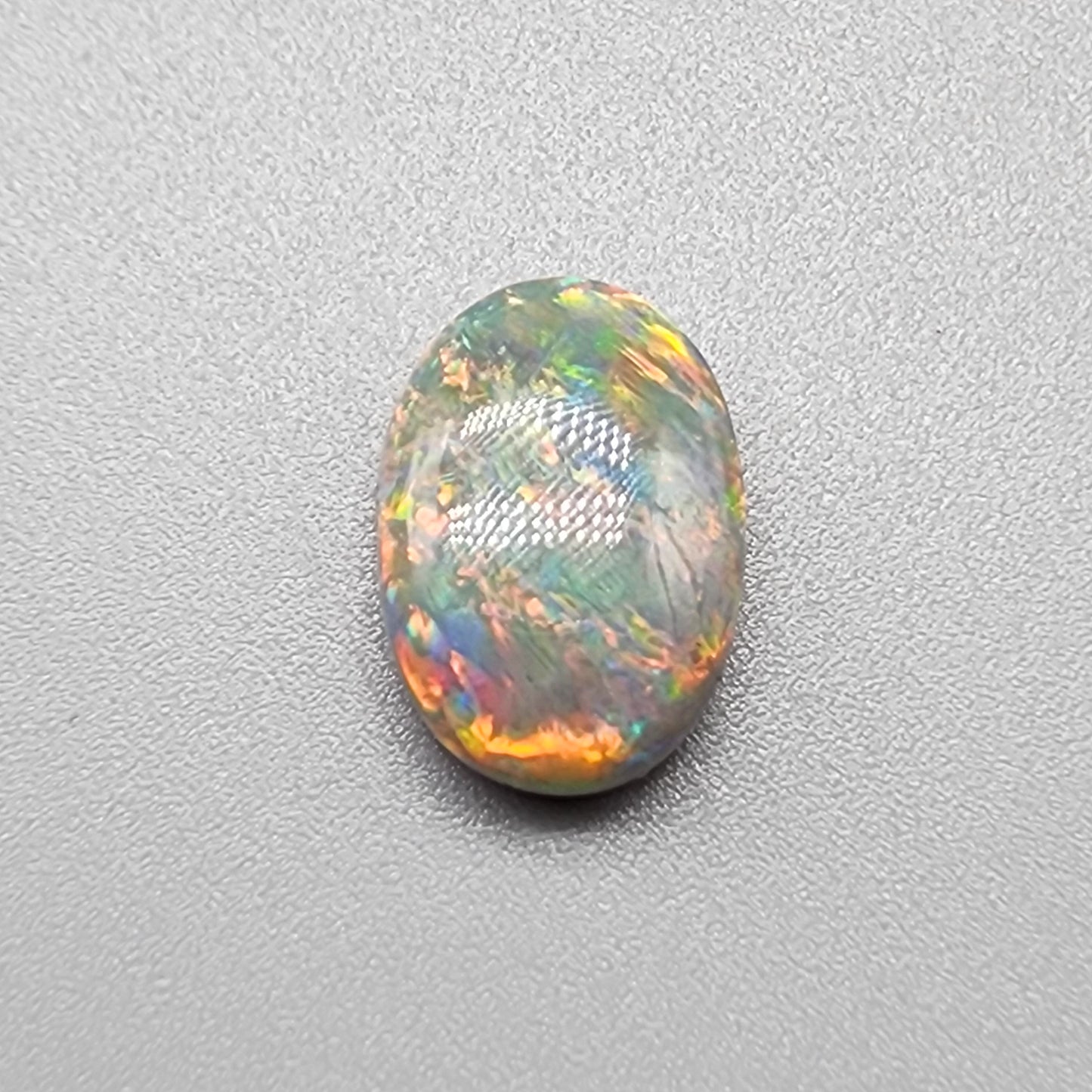 4cts Black Opal with a warm color pallet an mixed patterns