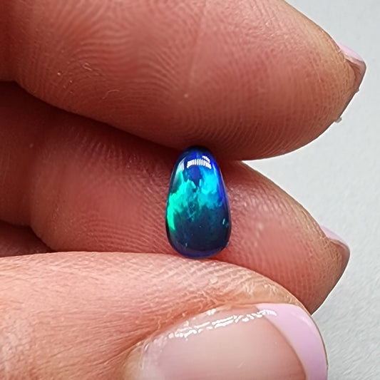 1.15 cts black Opal with vivid teal and broad flash pattern