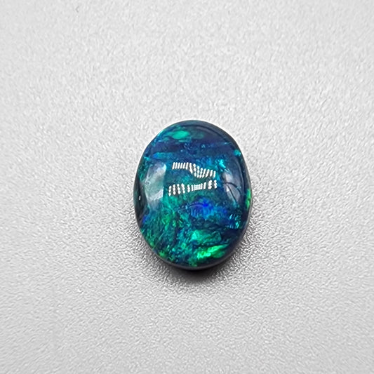 3.0ct black Opal with a marbled pallet of blues and greens