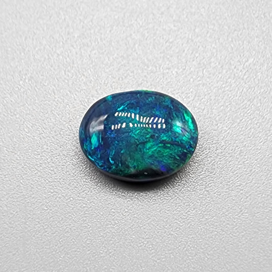 3.0ct black Opal with a marbled pallet of blues and greens