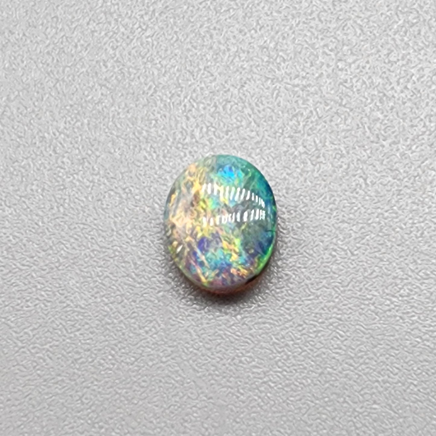 0.55ct Dark Opal with a multicolor striated pattern