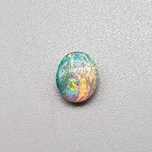 0.55ct Dark Opal with a multicolor striated pattern