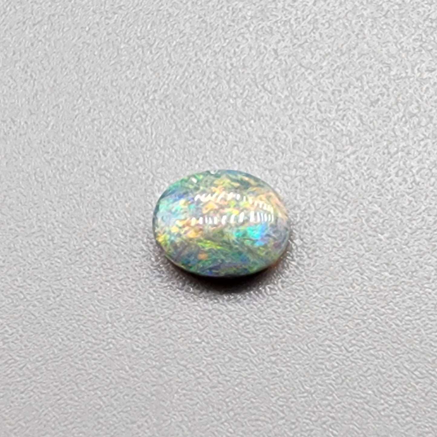 0.55ct Dark Opal with a multicolor striated pattern