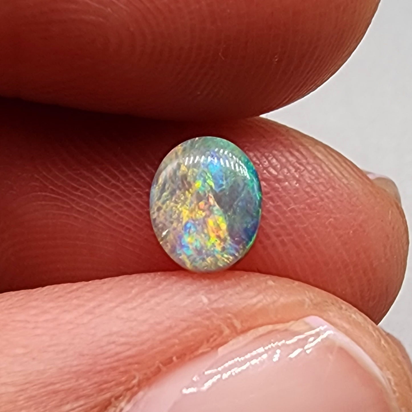 0.55ct Dark Opal with a multicolor striated pattern