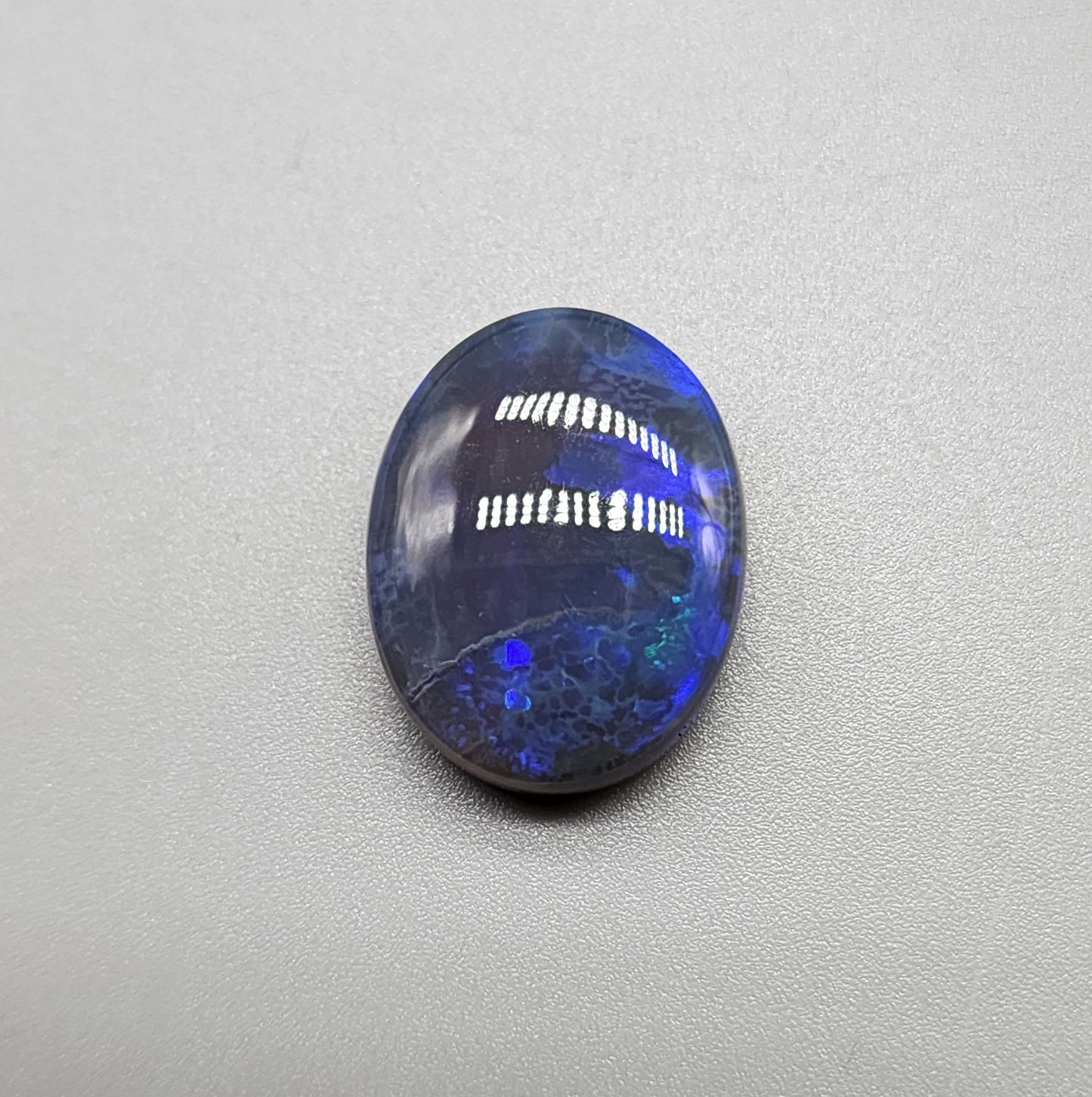 Large 11.40cts black Crystal opal  with a dark blue color palette