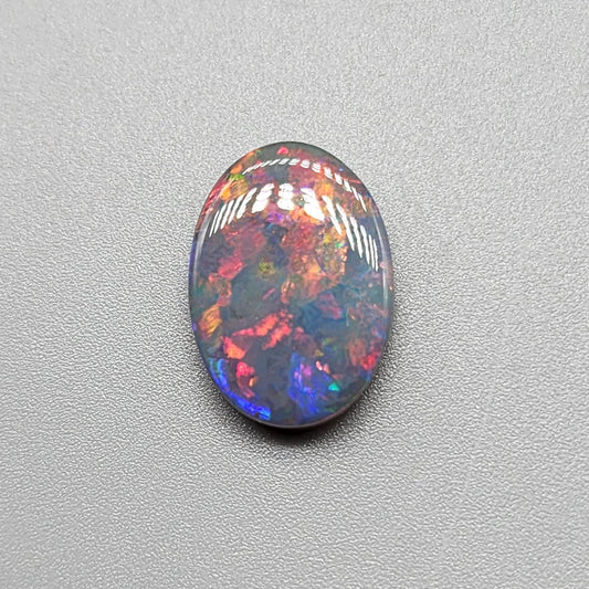 3.95cts Black Opal with a Red blue color palette and well distributed pattern