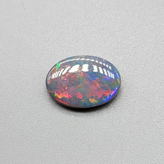 3.95cts Black Opal with a Red blue color palette and well distributed pattern