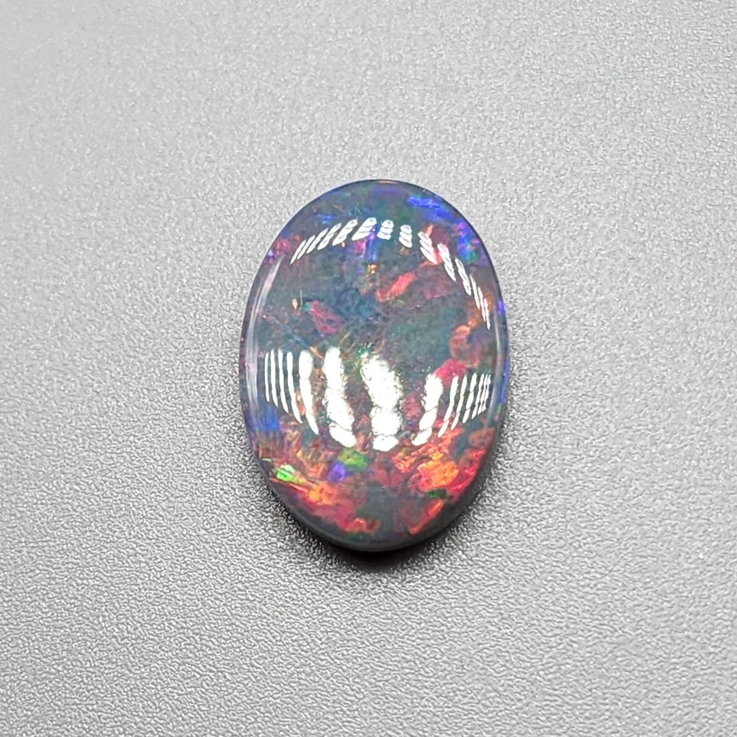 3.95cts Black Opal with a Red blue color palette and well distributed pattern