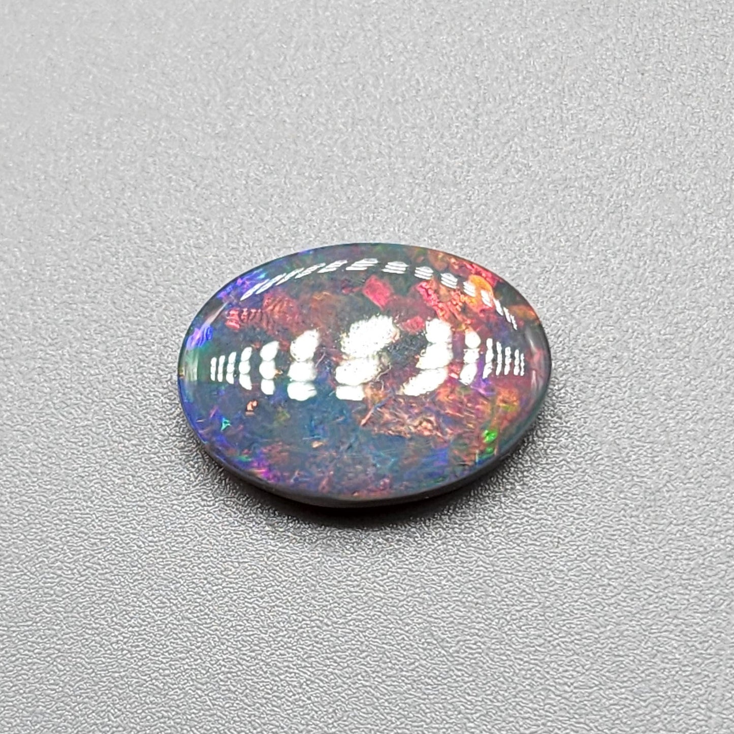 3.95cts Black Opal with a Red blue color palette and well distributed pattern