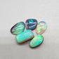 Assorted Black and Crystal opals showing a vivid aray of green hues