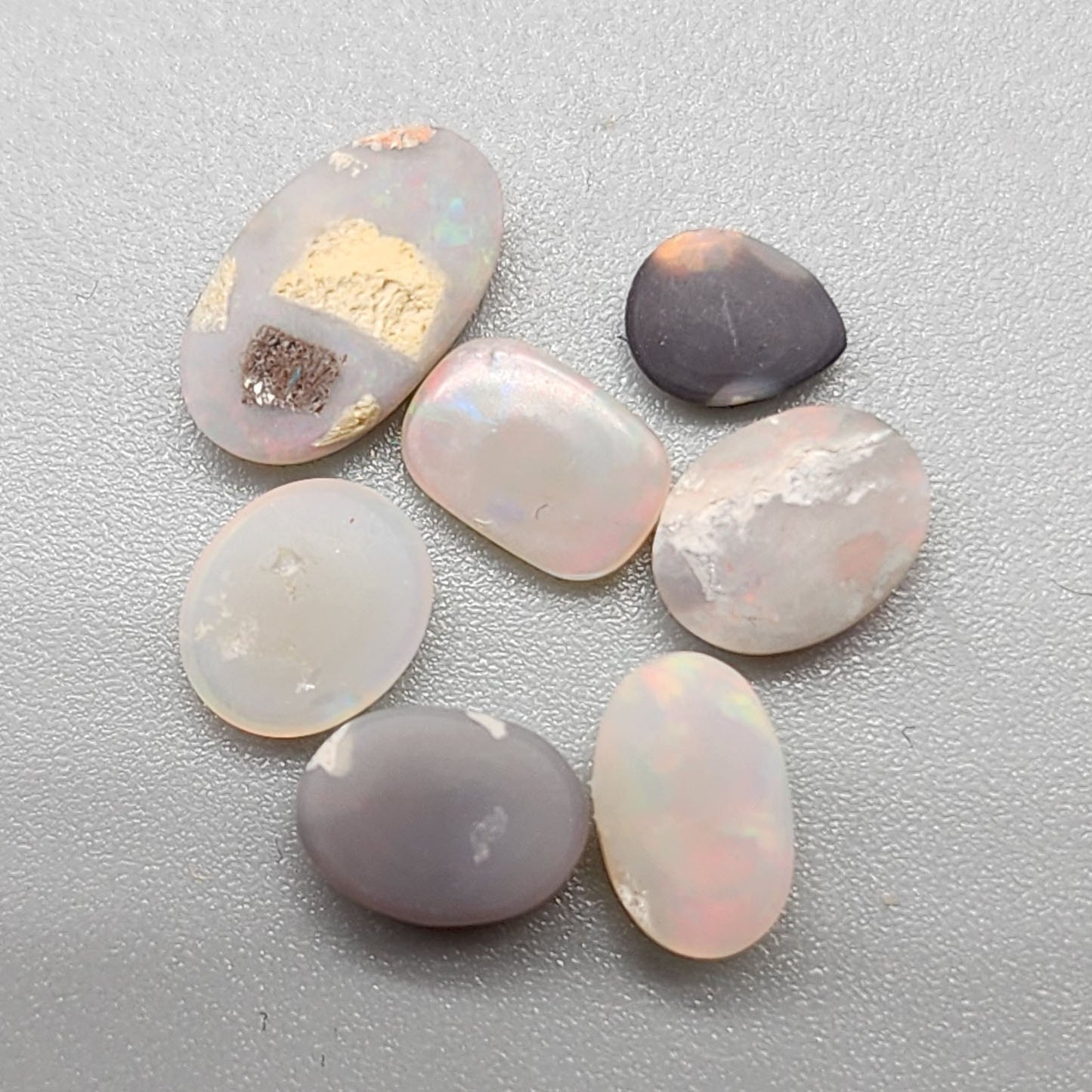 Assorted Black and Dark opals with warm, sunset color palettes