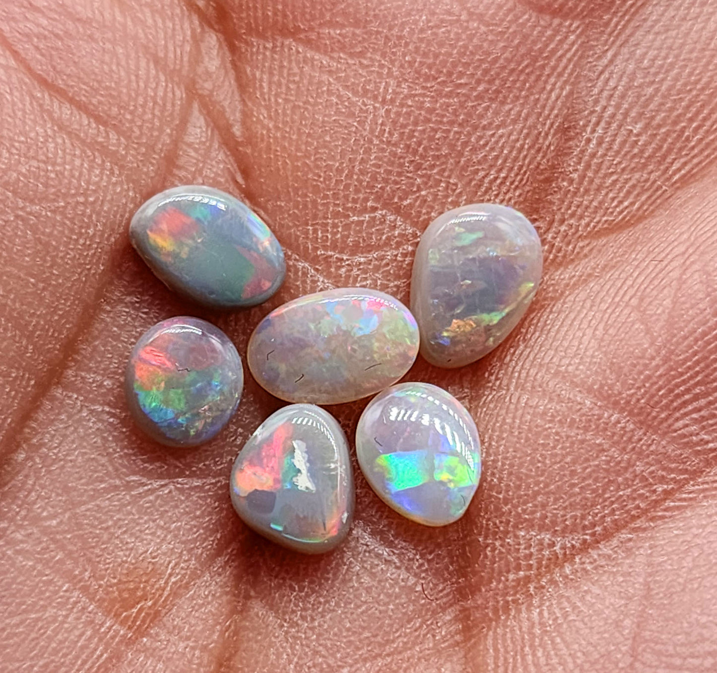 Assortment of dark opals with lovely pastel color palette