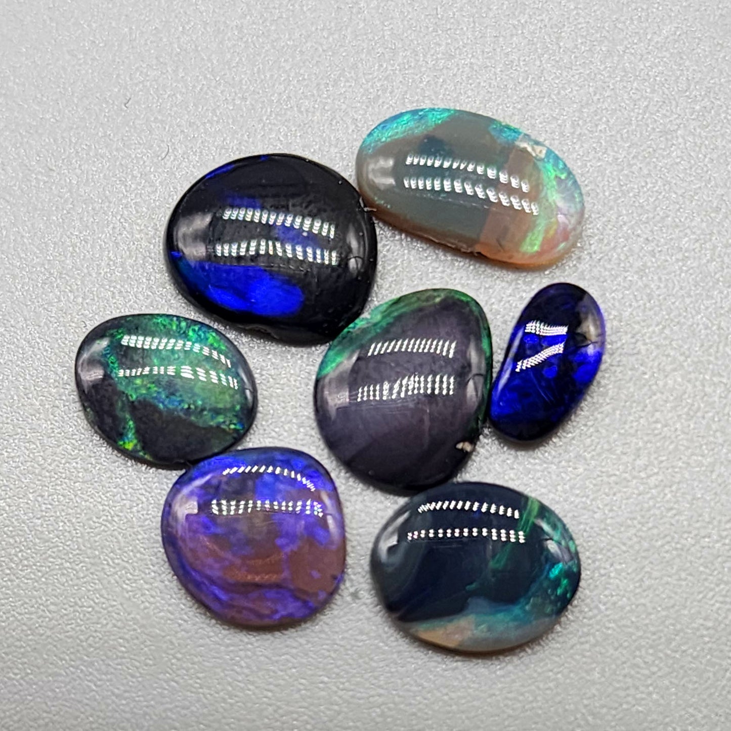 Assortment of black opals with marbling of color and potch