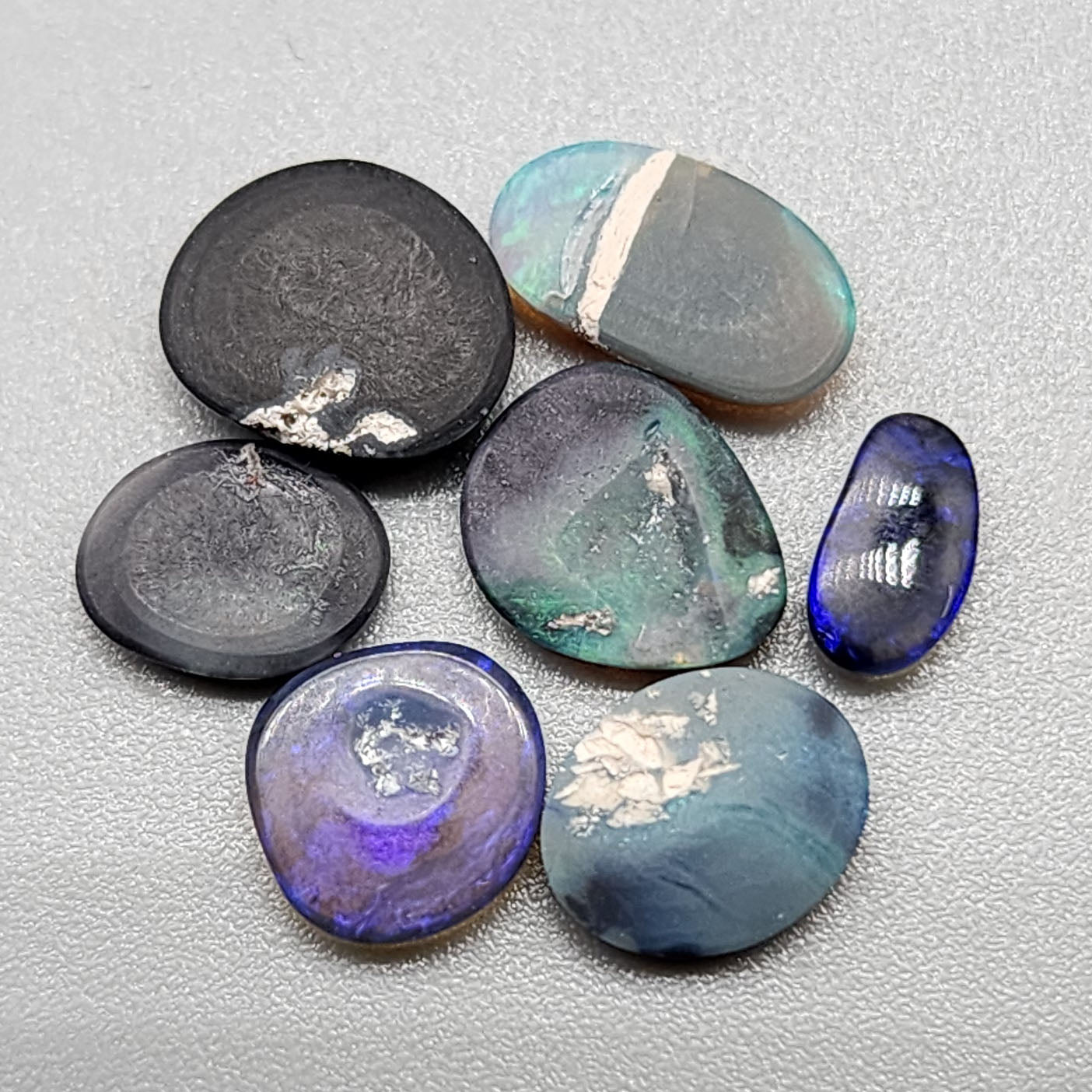 Assortment of black opals with marbling of color and potch