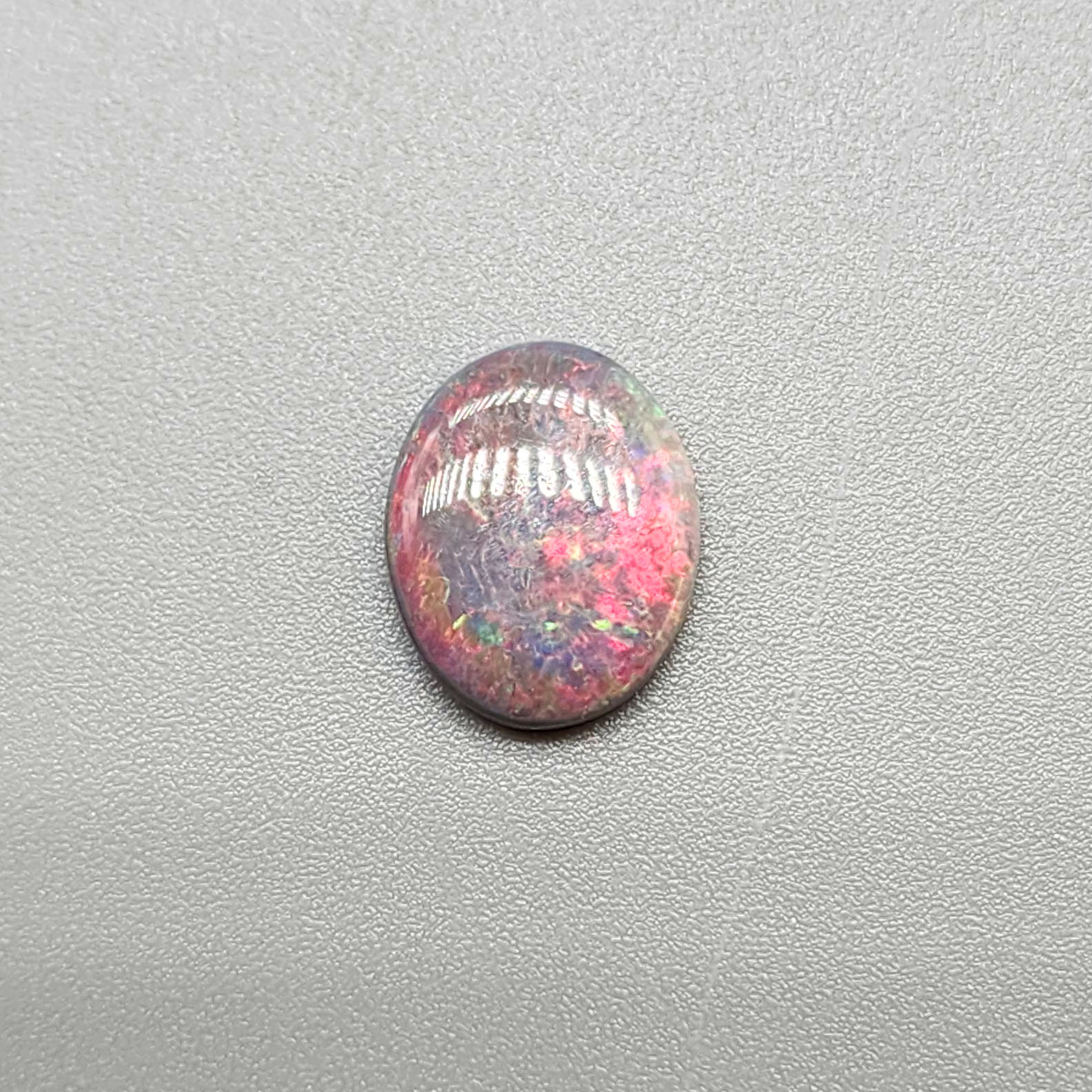 1.5cts Dark Opal with vivid pinkls and flecks of green