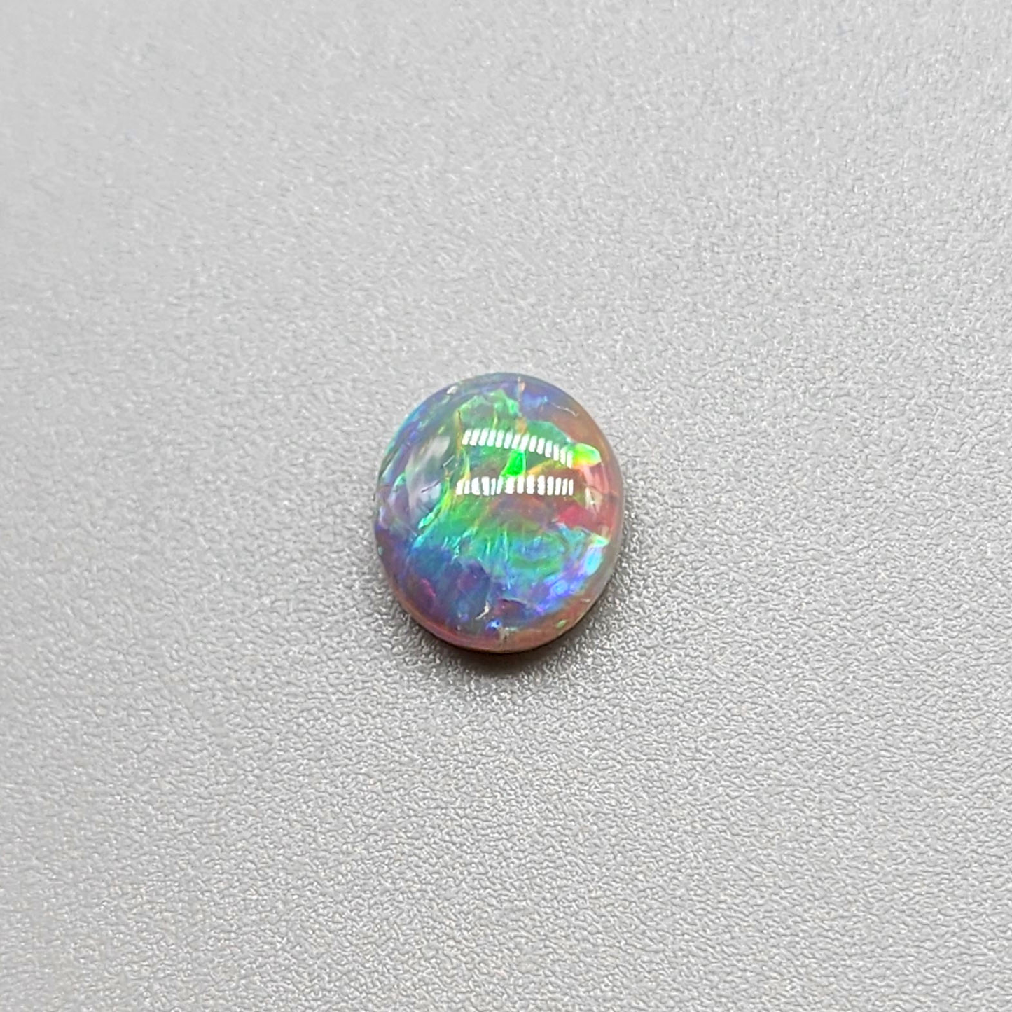 1.25cts  Dark Opal with vivid multi color pastel color palette