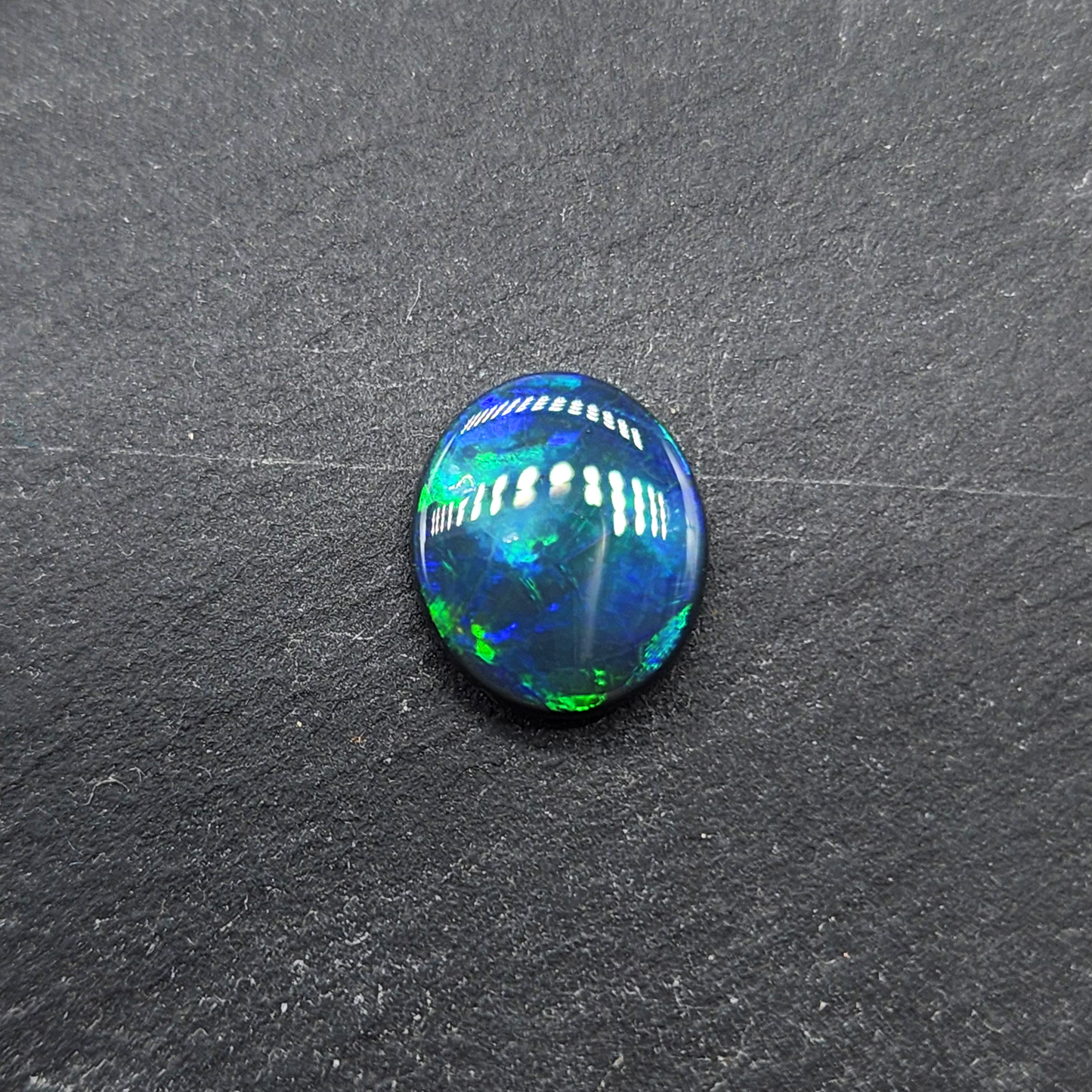 Black opal with bright green-blue  broadflash pattern