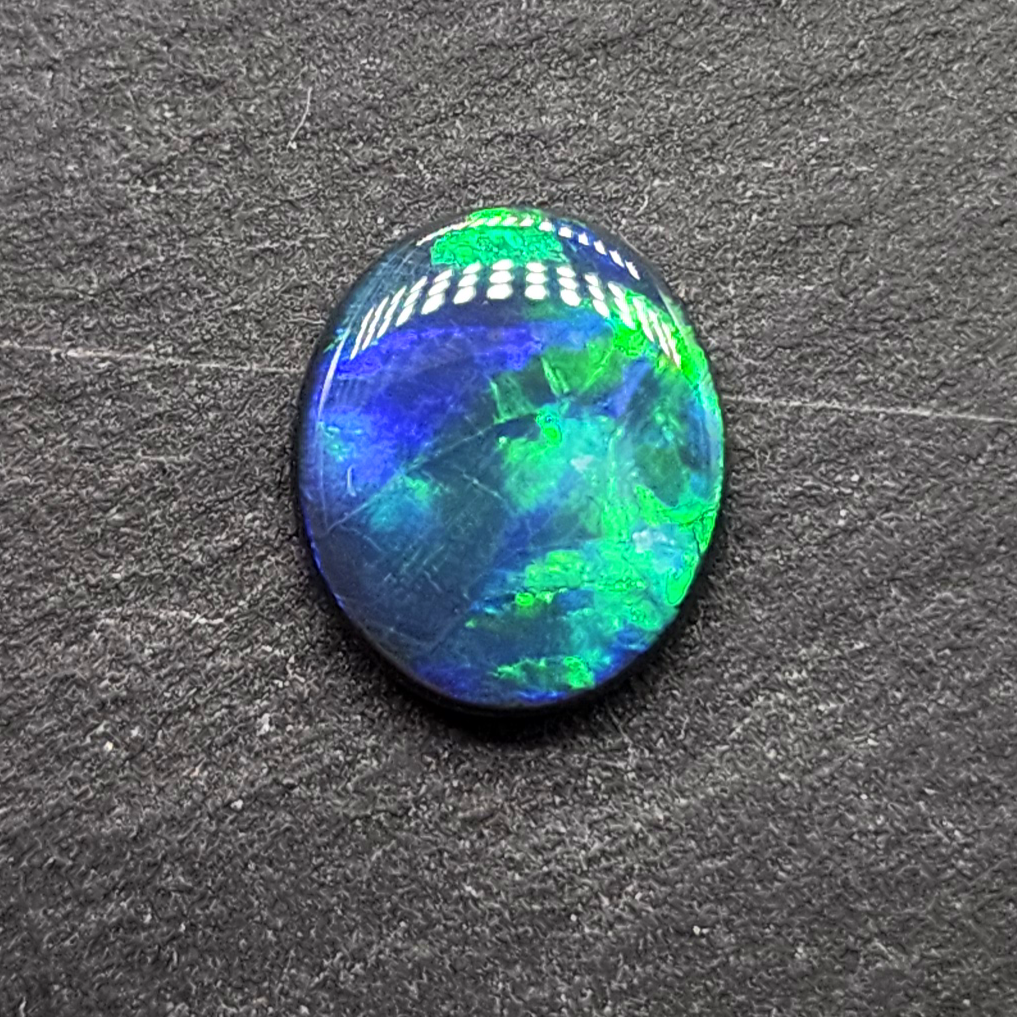 Black opal with bright green-blue  broadflash pattern