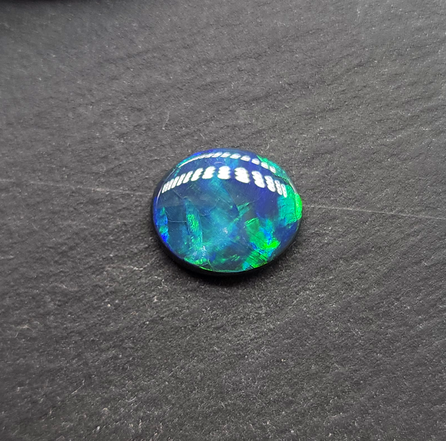 Black opal with bright green-blue  broadflash pattern