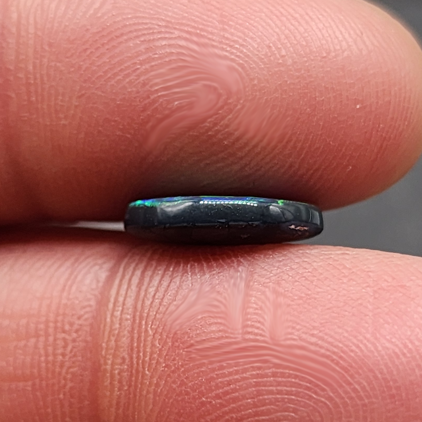 Black opal with bright green-blue  broadflash pattern