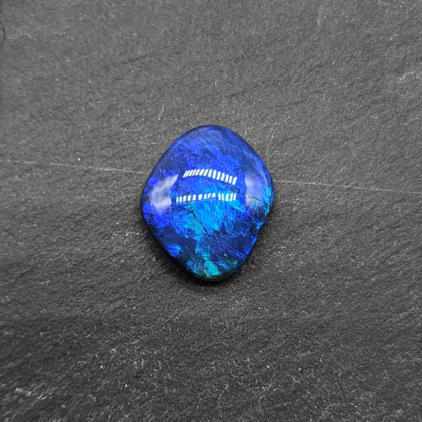 Gem black opal with dence patterning. this stone exhibits a lovely blue ombre effect with movement