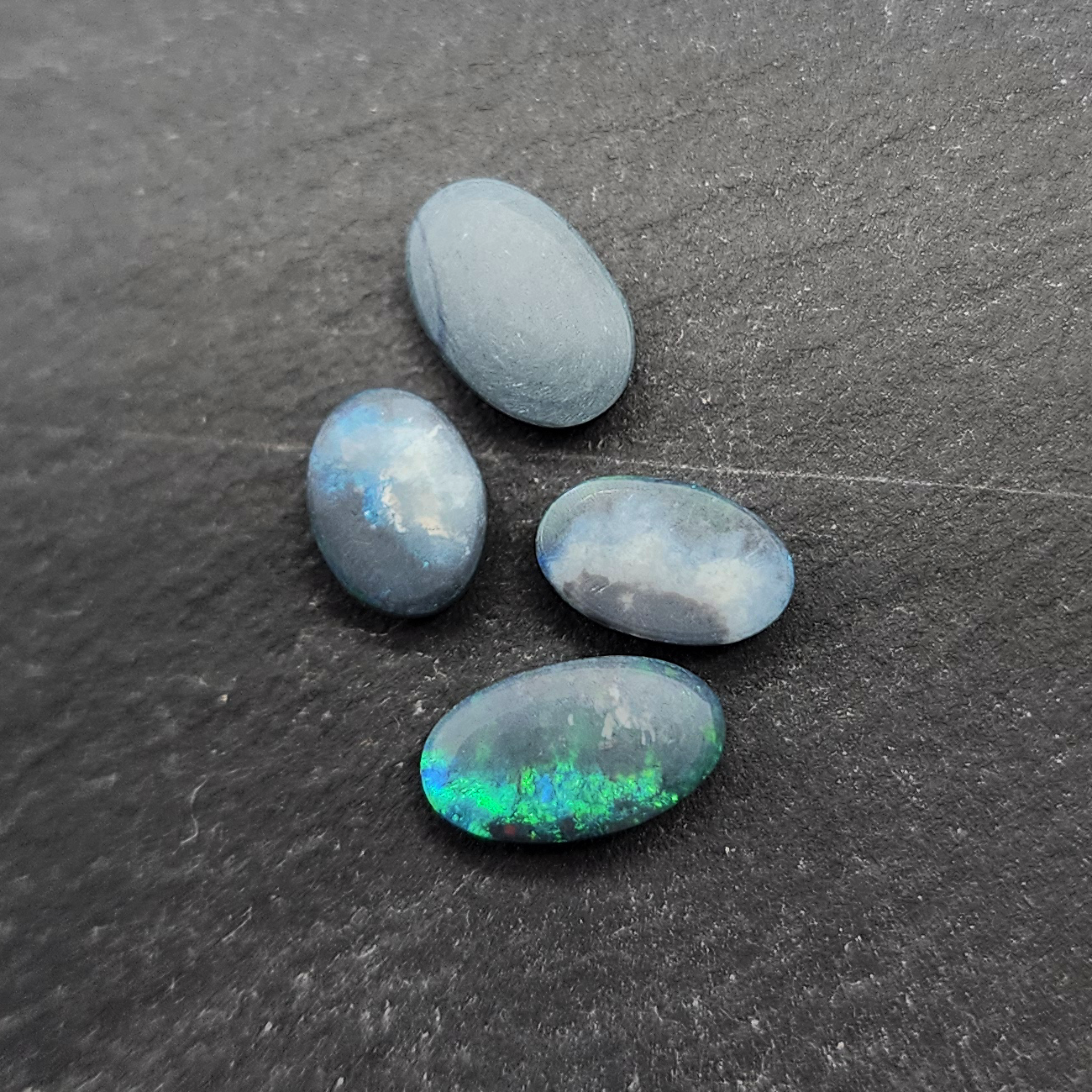 Black Opals with vivid green-blue color play and mossy patterns