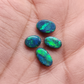 Black Opals with vivid green-blue color play and mossy patterns