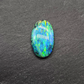 Black opal with a mossy pattern and a green multi color palette.