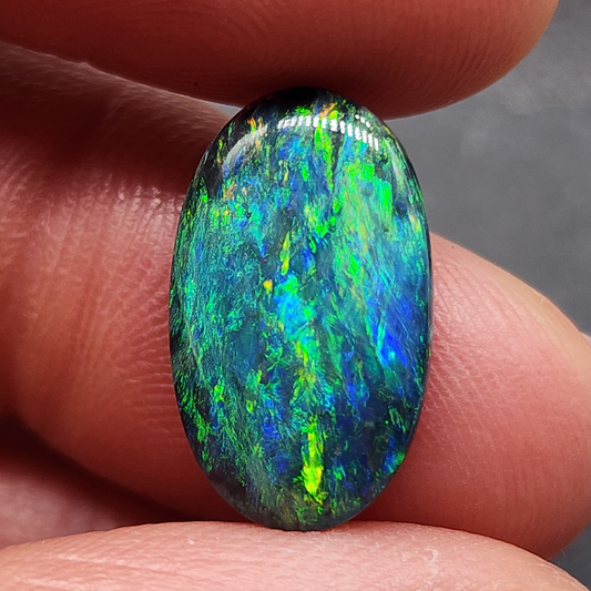 Black opal with a mossy pattern and a green multi color palette.