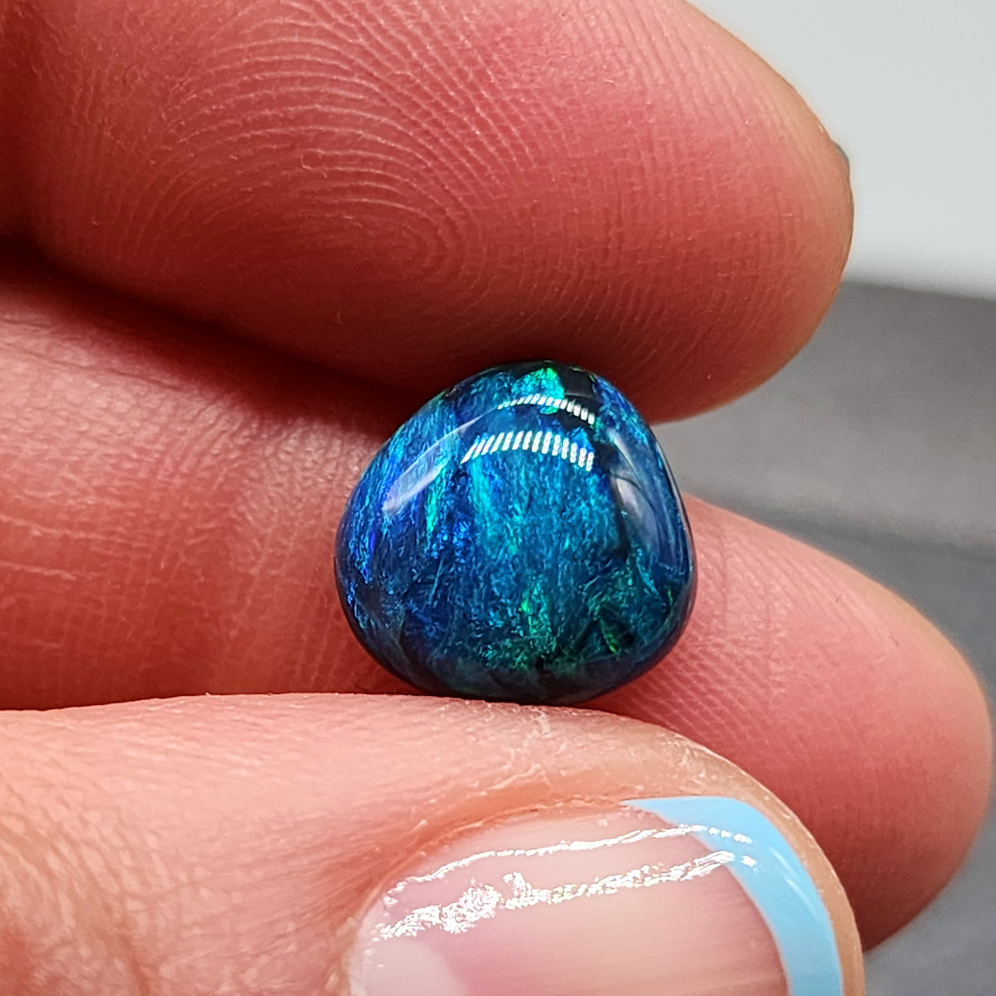 Stunning Black opal with a vivid Green blue color palette and mossy pattern.