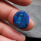 Black opal with vivid blue mossy color play and hints of blue