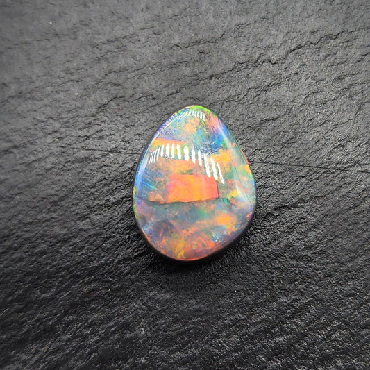 Top gem black opal with vivid red-multi color flagstone pattern